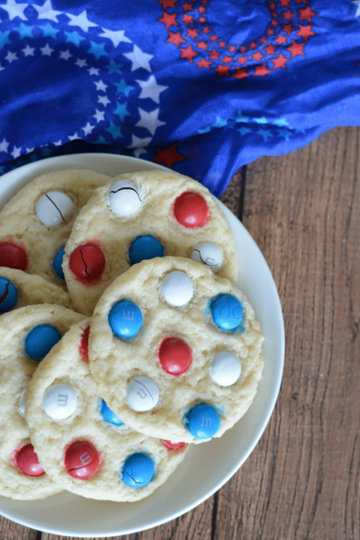 These Red, White & Blue M&M Sugar Cookies are super easy to whip up for your 4th of July celebration! Have the little ones join in and let them add the M&Ms on top for some added fun!